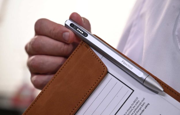 male hand holding clipboard silver pen clipped white shirt